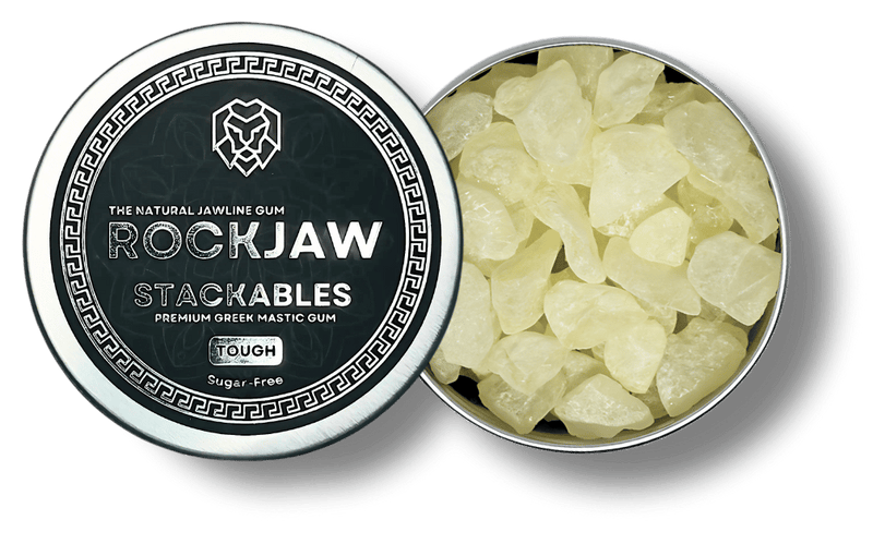 An open ROCKJAW Stackables tin beside its lid, filled with pieces of mastic gum